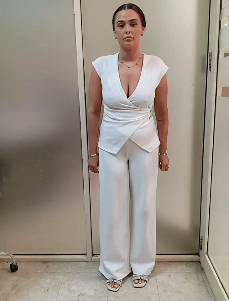 Woman in a white pantsuit.