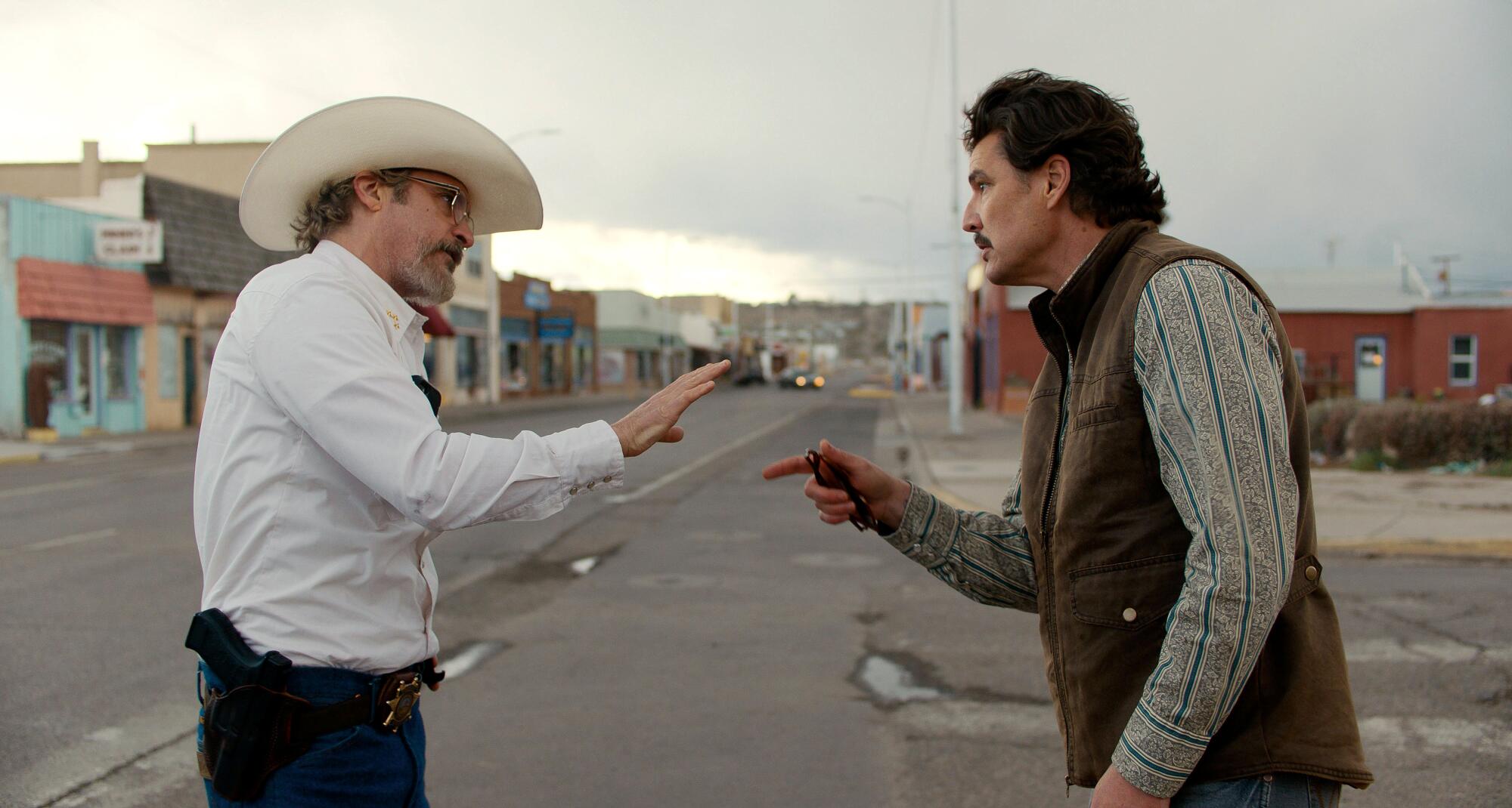 Joaquin Phoenix, left, and Pedro Pascal in the movie "Eddington."