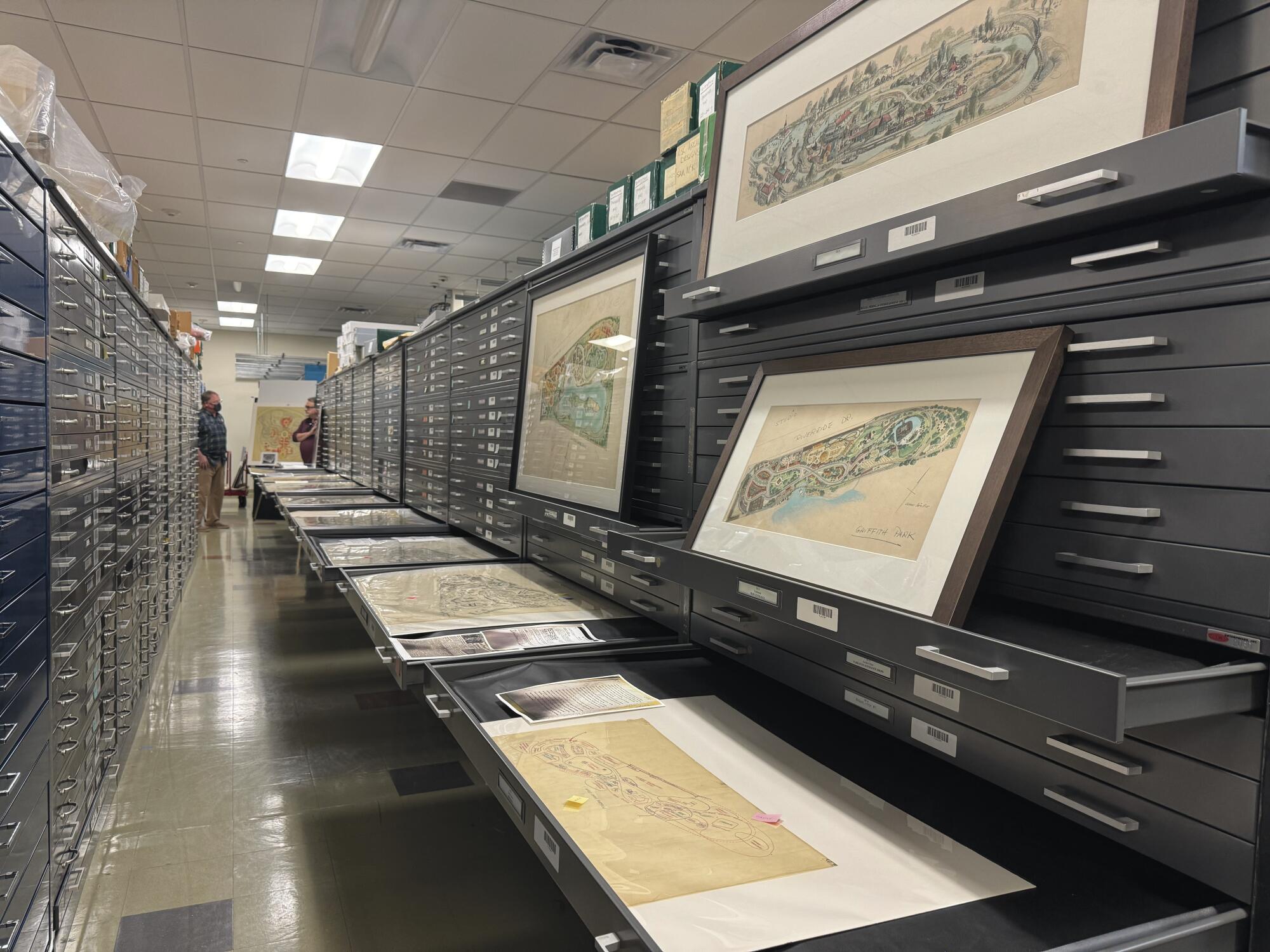 Filing cabinets with multiple maps on display.