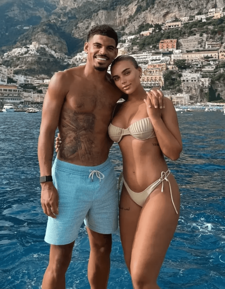 Couple posing for a photo in swimsuits.