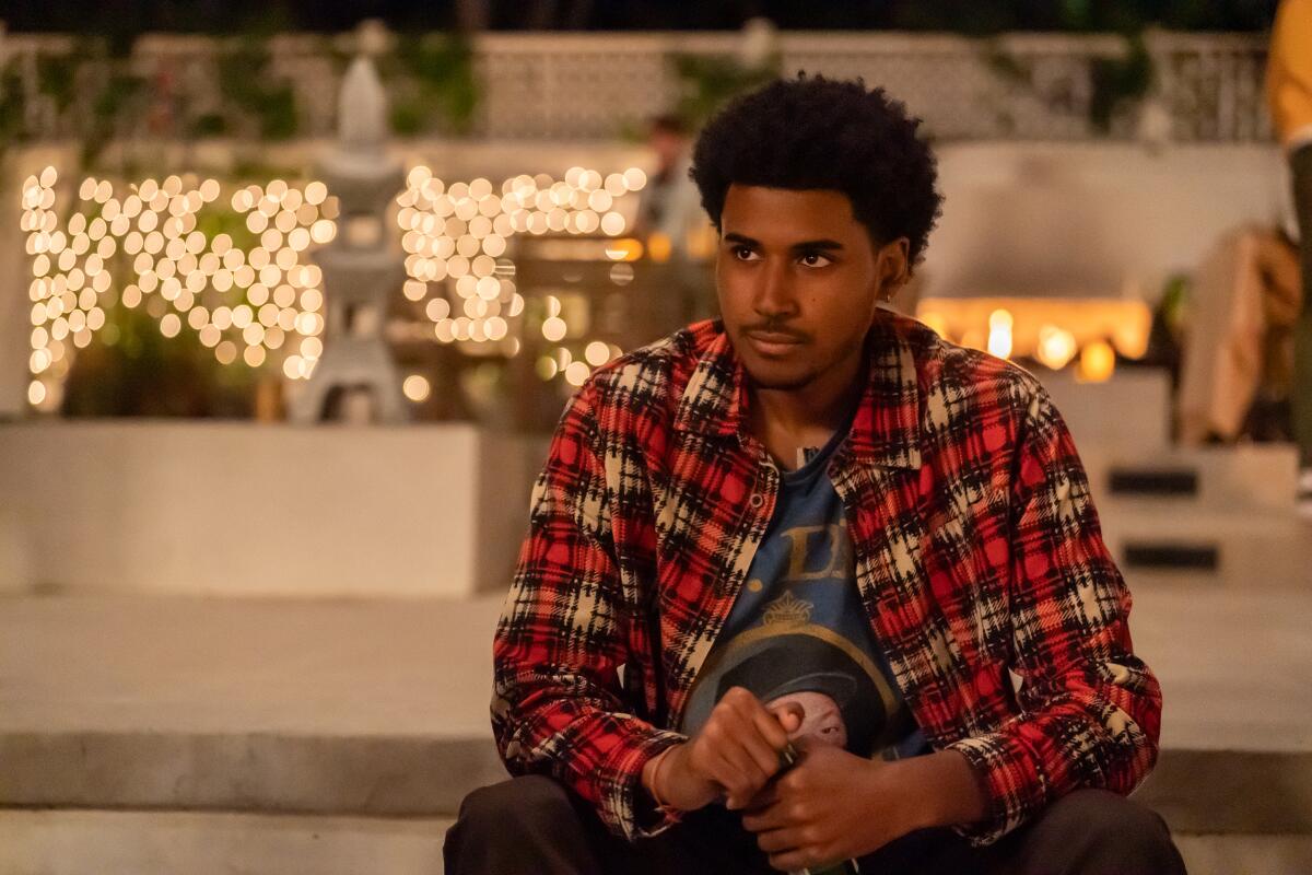 A teenage boy in a plaid shirt