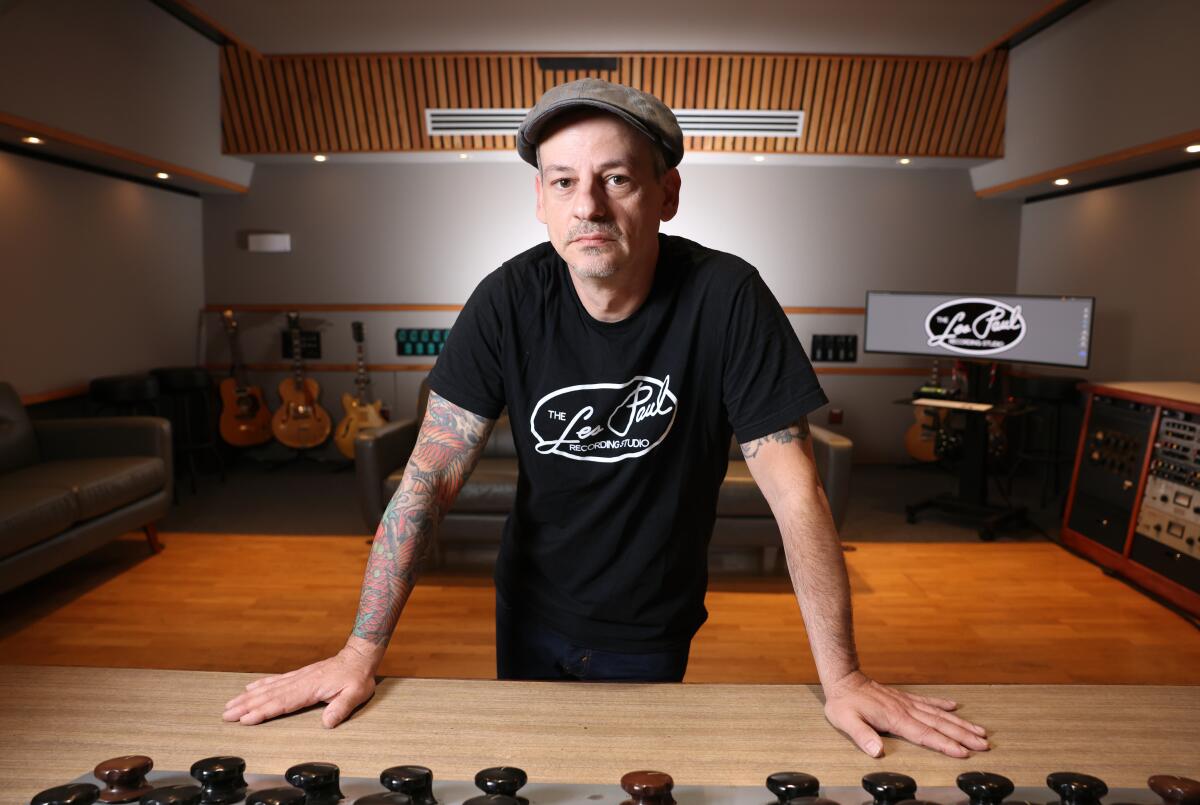 Man leaning on a recording console