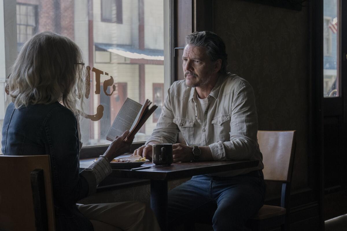 A woman and a man seated at a diner table.