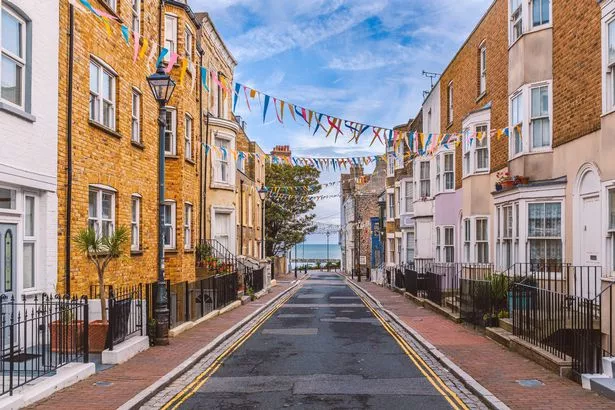 Clear skies, narrow street, colourful buildings