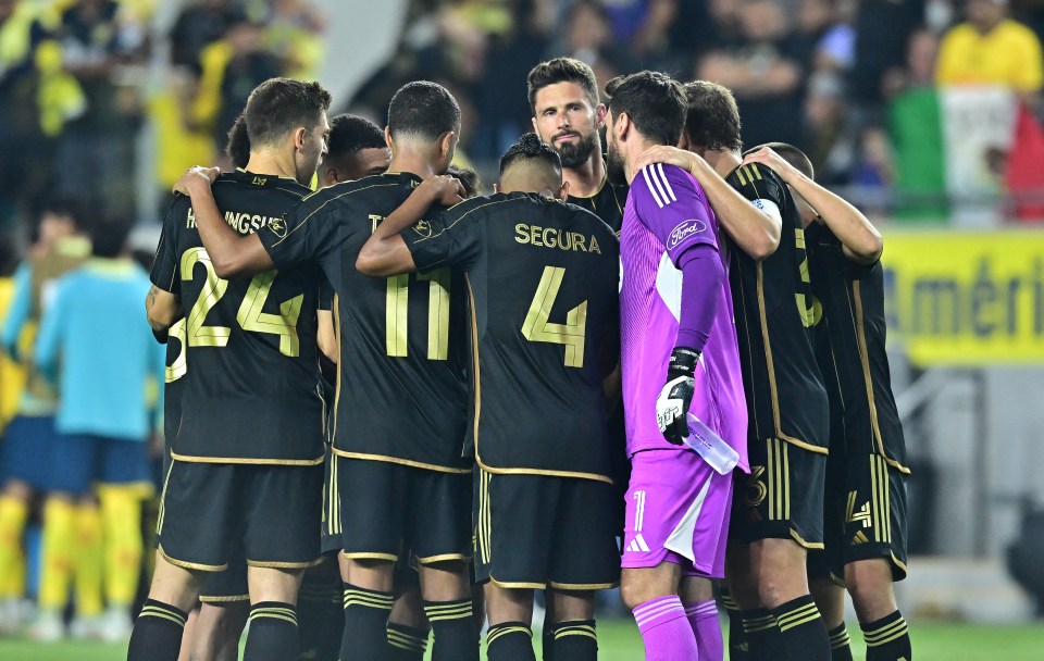 LAFC soccer players huddle together on the field.