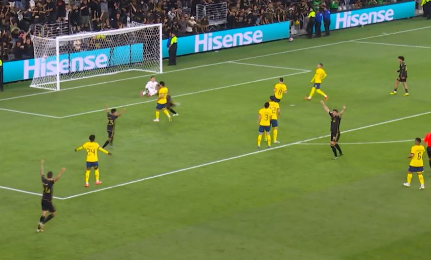 Soccer players celebrating a goal.