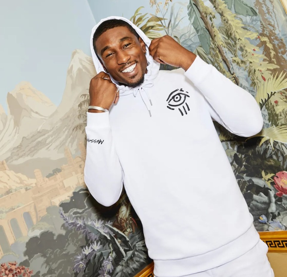 Man in white hoodie with eye design.