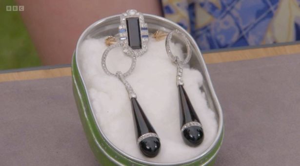He found a spectacular pair of drop earrings set in platinum and a sapphire ring