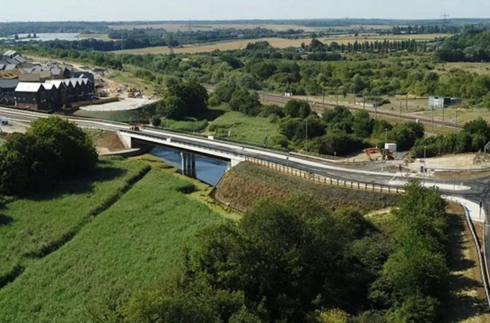 Aerial view of Ebbsfleet garden city, showing a new bridge and road construction.