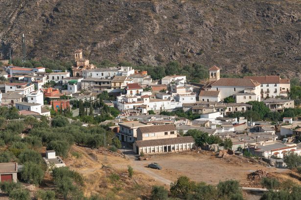 Aerial image of city of Albanchez showing houses and hill in the background