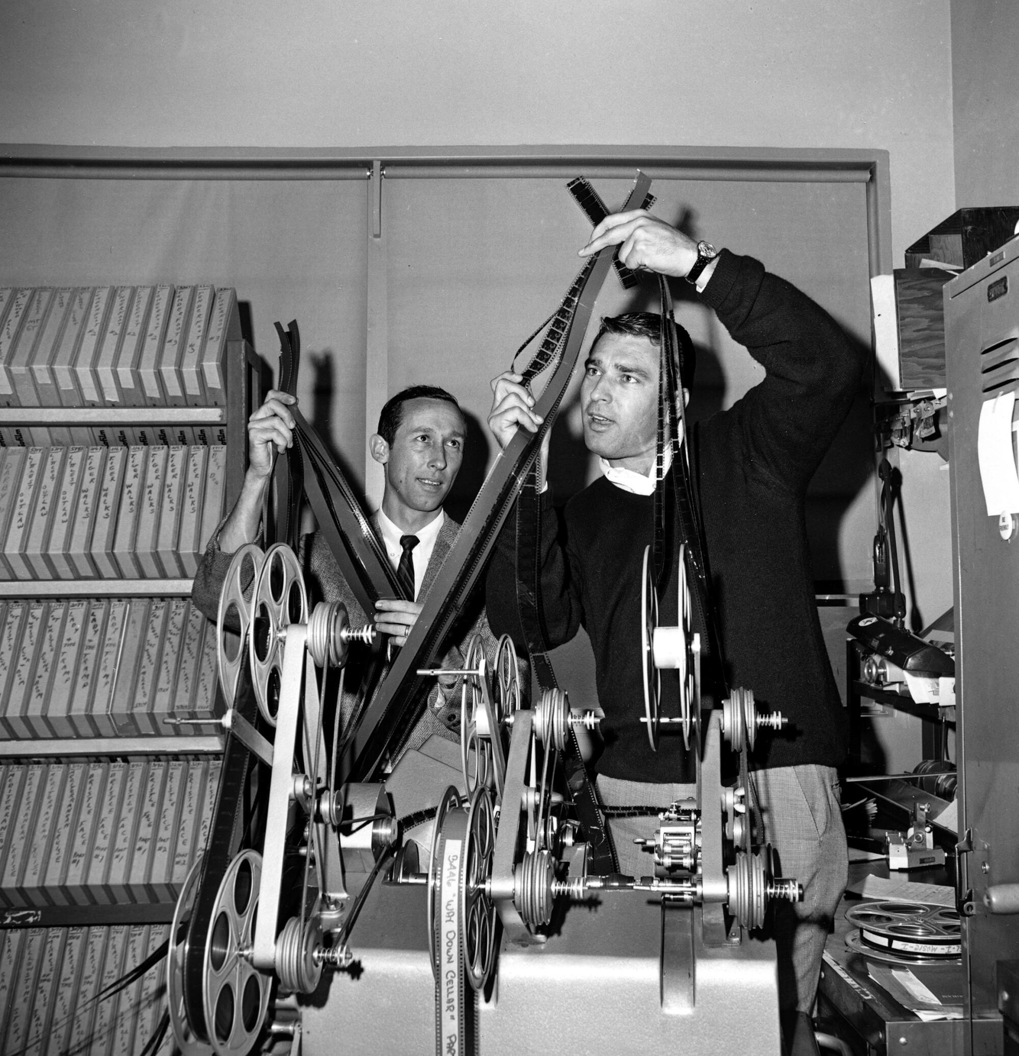 Roy Disney, left, and Ron Miller check over film strips