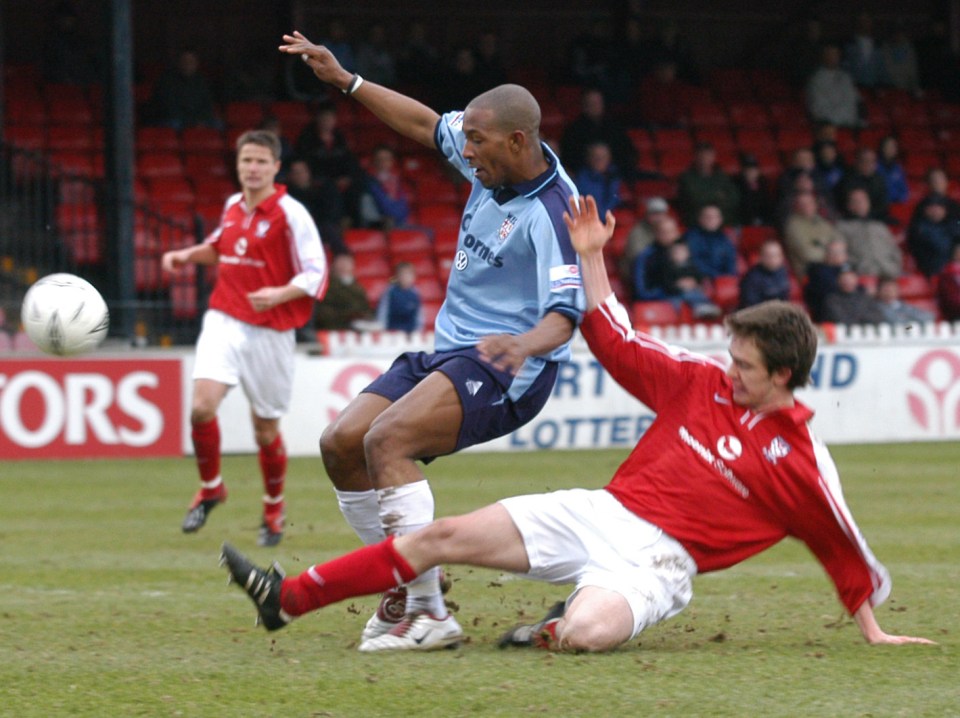 Soccer player tackled during a game.