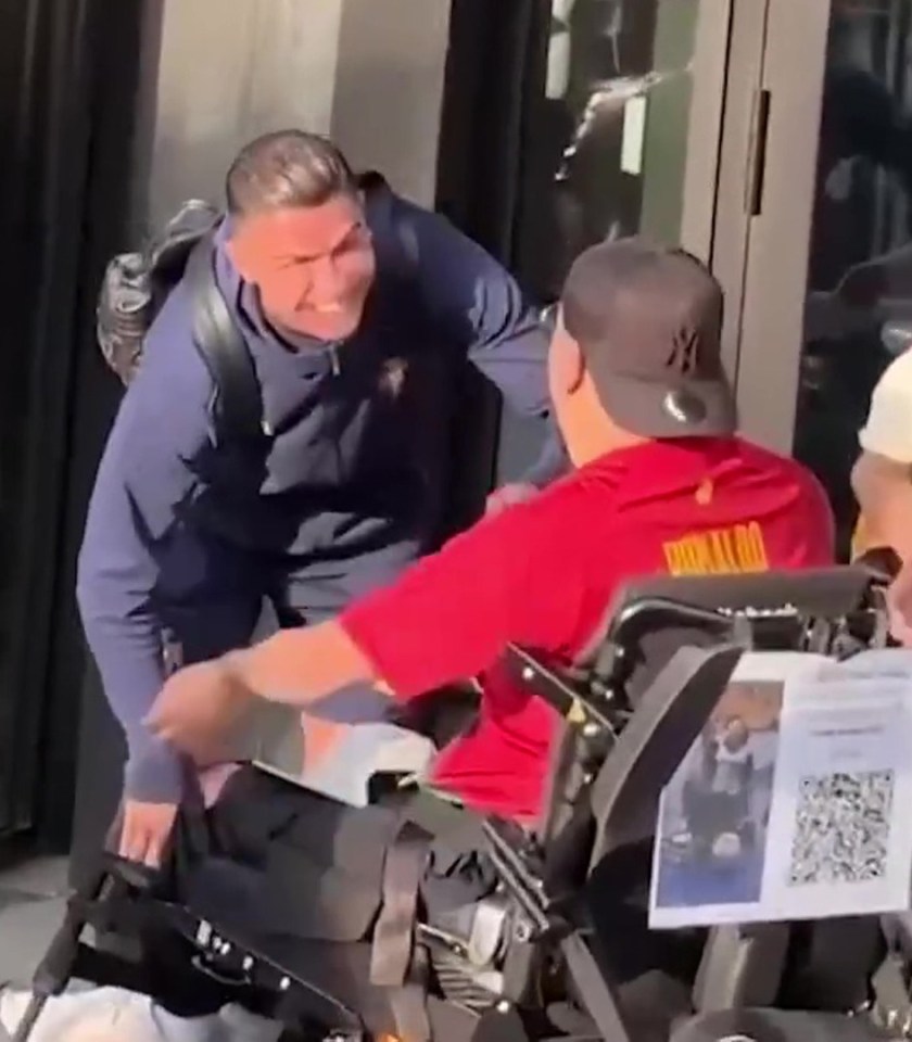 Cristiano Ronaldo helps a person in a wheelchair.