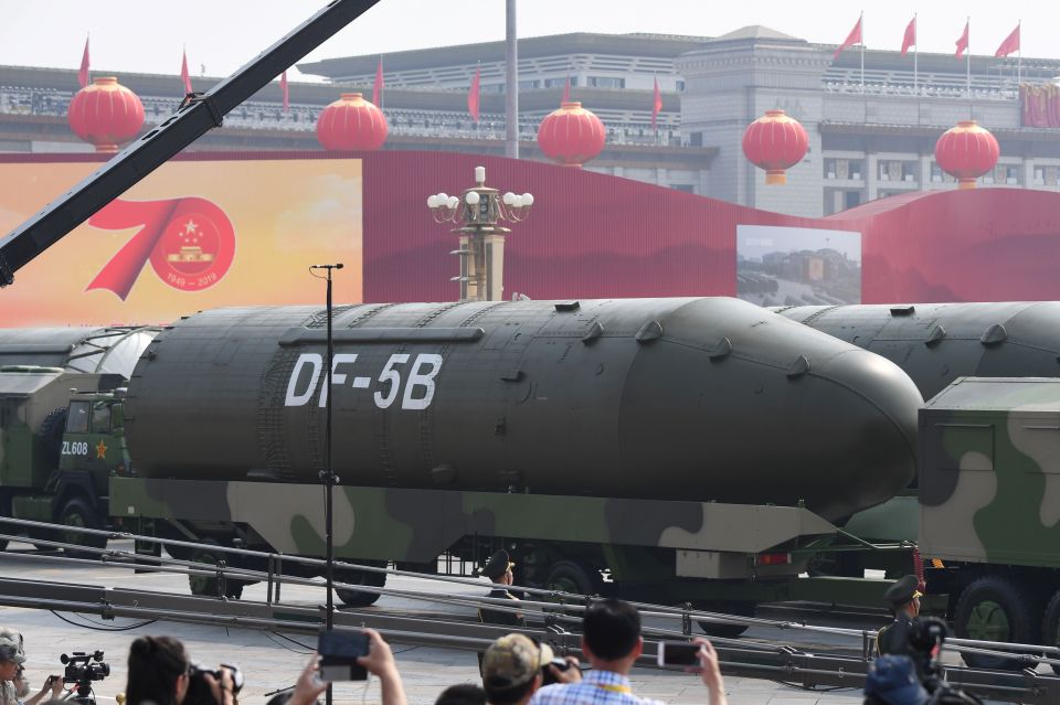 DF-5B intercontinental ballistic missiles on military transport vehicles in Tiananmen Square during a military parade.