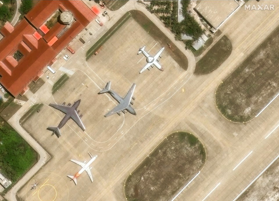 Aerial view of multiple aircraft parked on a tarmac.