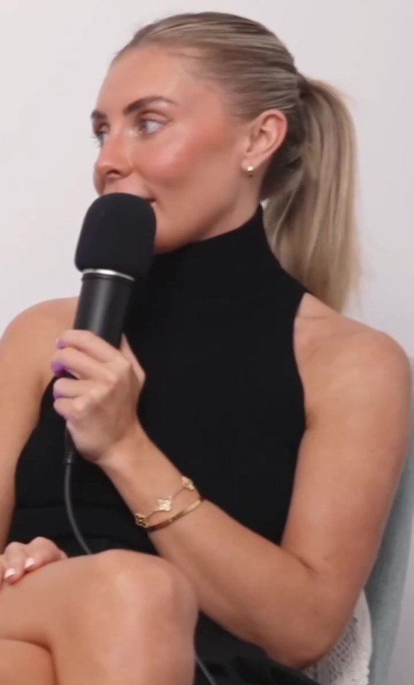 Woman holding a microphone during an interview.