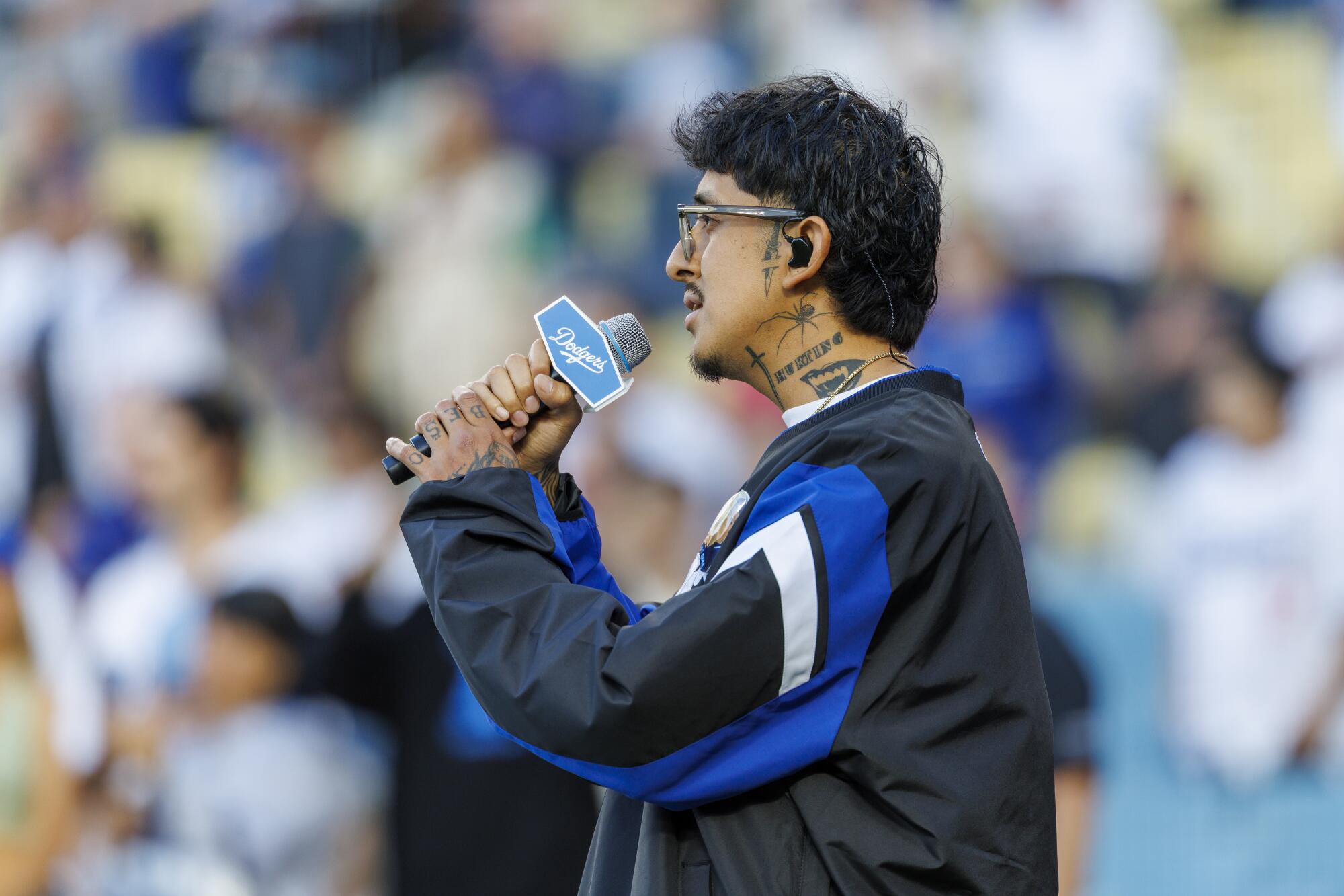 Cuco sings the Star Spangled Banner before the Dodgers game against the Arizona Diamondbacks at Dodger Stadium