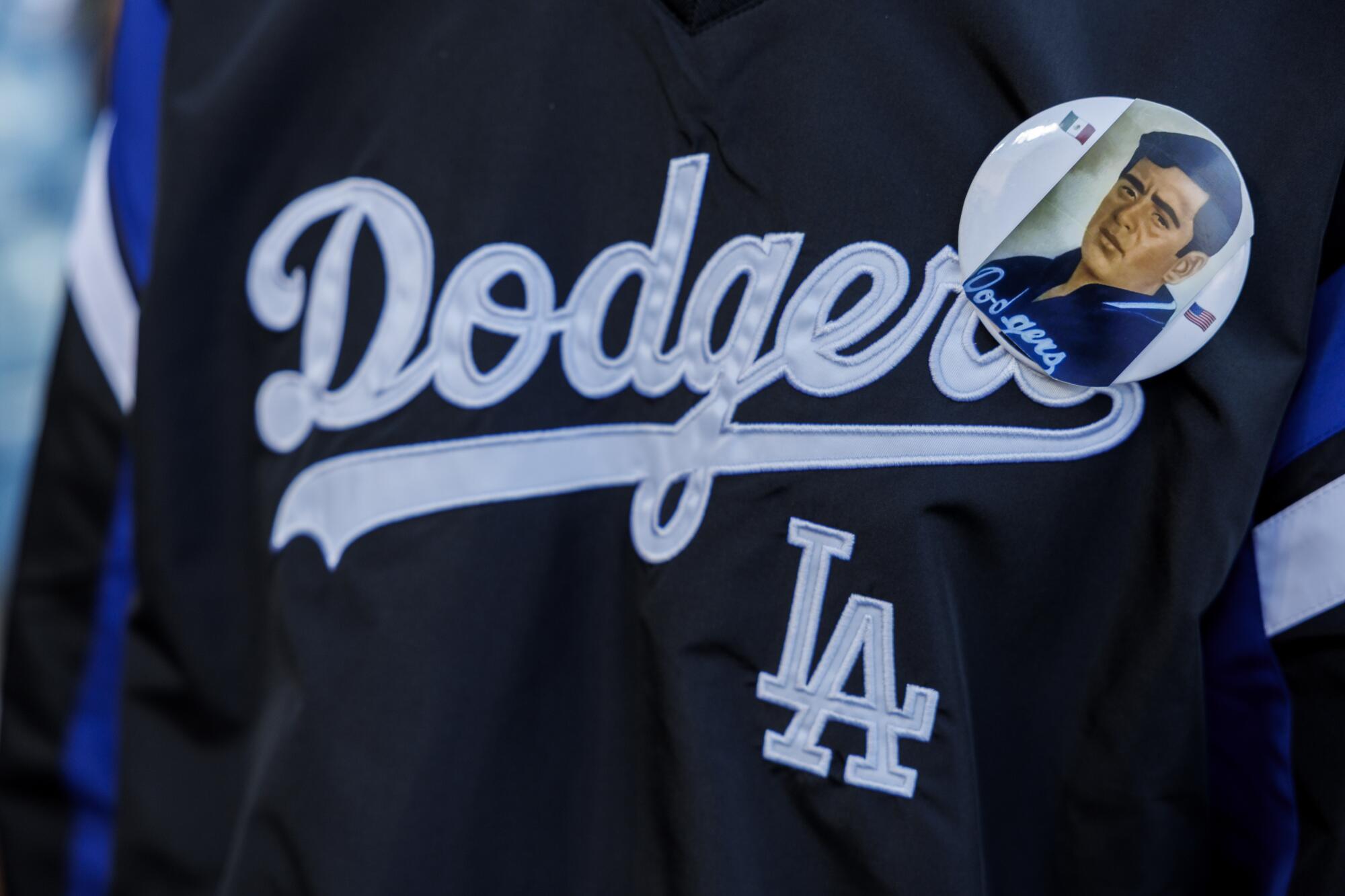 Cuco wears a pin with his grandfather Jaime Mendoza's picture while singing the Star Spangled Banner before the Dodgers game
