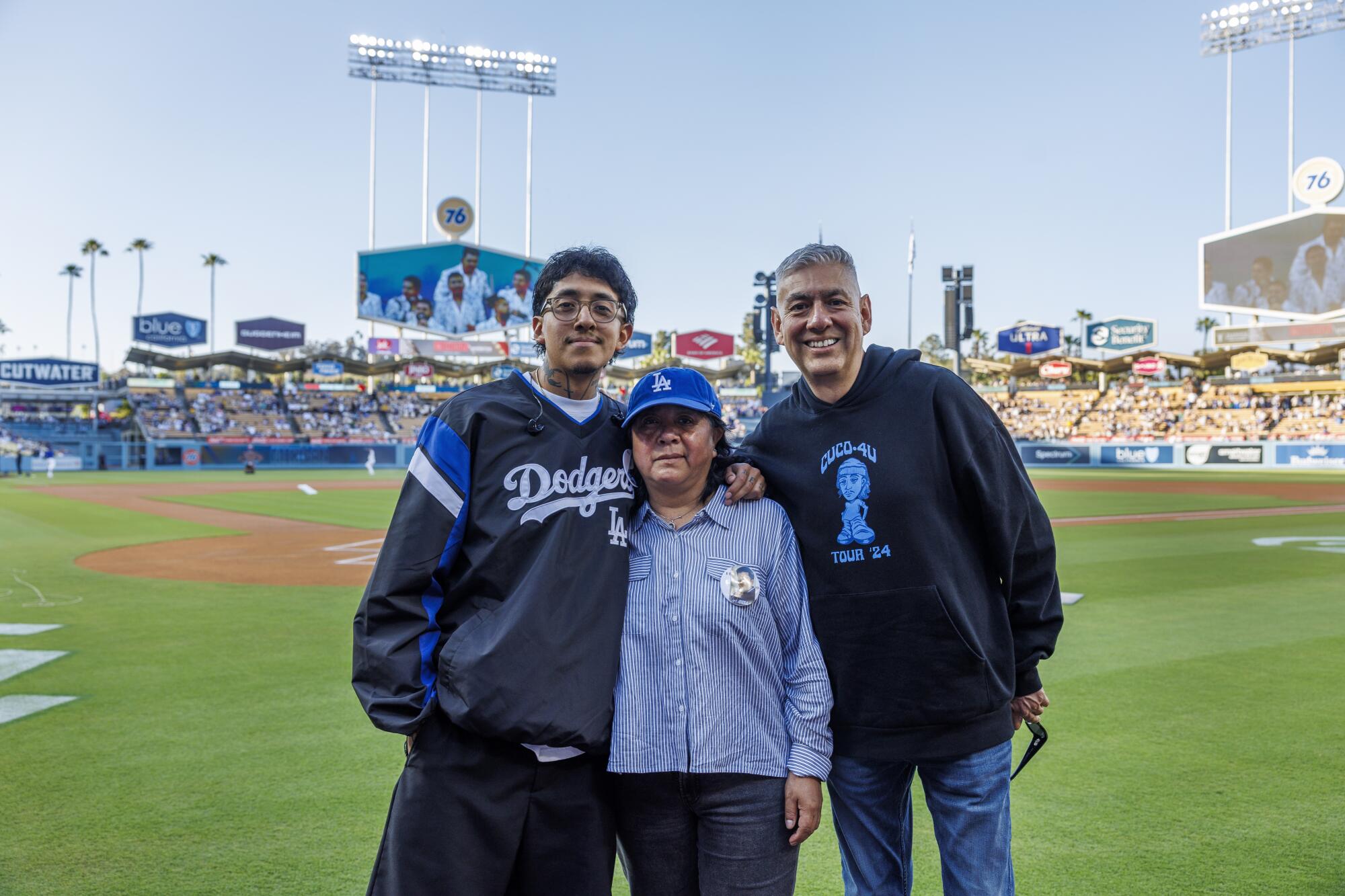 Cuco poses with his mom Irma Mendoza and his dad Adolfo Banos before singing the Star Spangled Banner before the Dodgers game