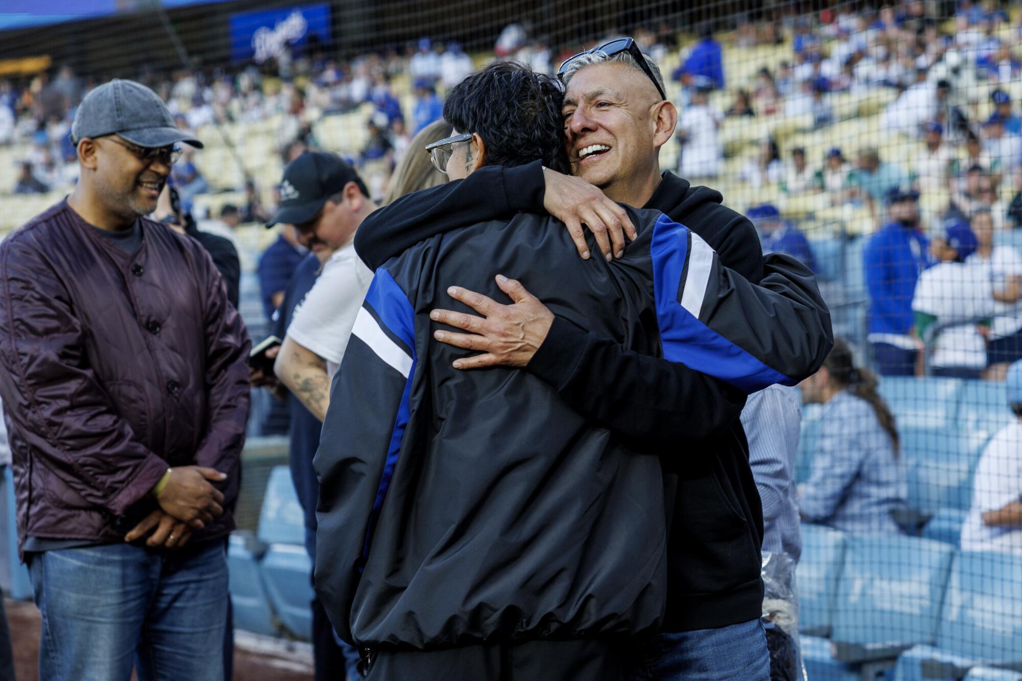 LOS ANGELES, CA - MAY 20, 2025: Cuco gets a hug from his dad Adolfo Banos after singing the Star Spangled Banner