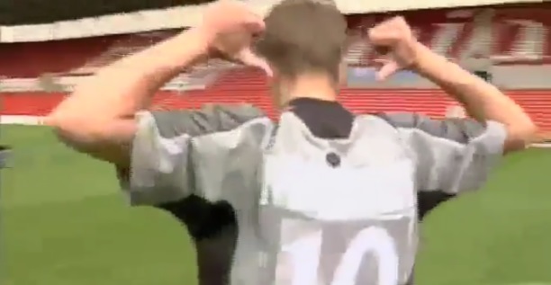 Soccer player with number 10 on their back making a gesture with their hands.