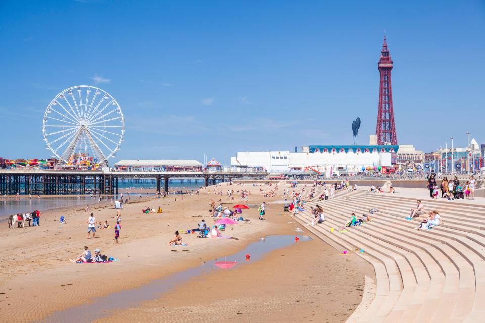 Blackpool beach with the Blackpool Tower and pier in the background.