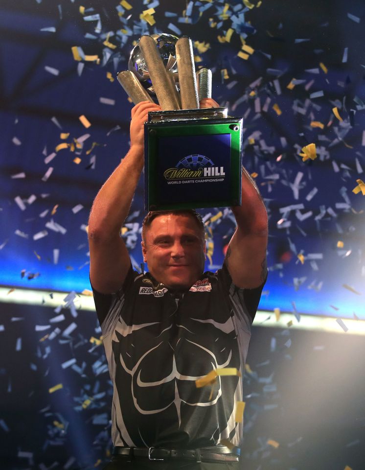 Gerwyn Price holding the William Hill World Darts Championship trophy.