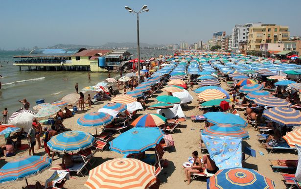 Image of rows of sunloungers and umbrellas on a beach in Durrës
