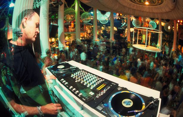 Image of DJ spinning at a club in Ibiza