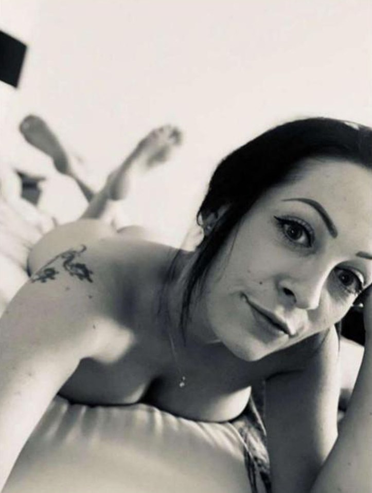 Black and white photo of a woman lying on a bed.