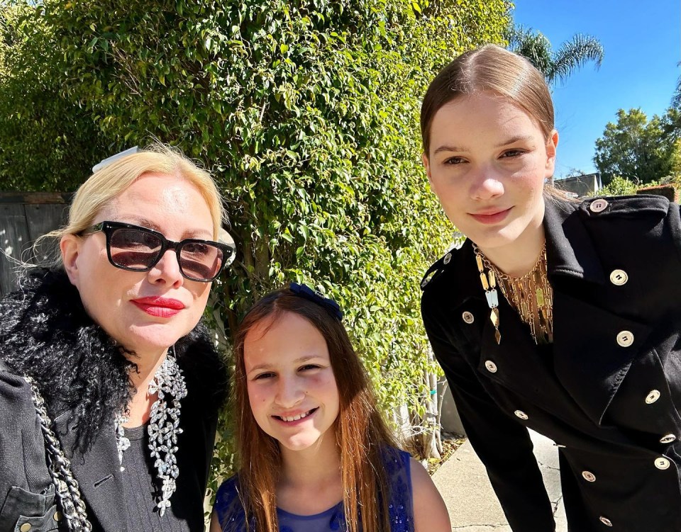 Woman and two girls posing for a photo.