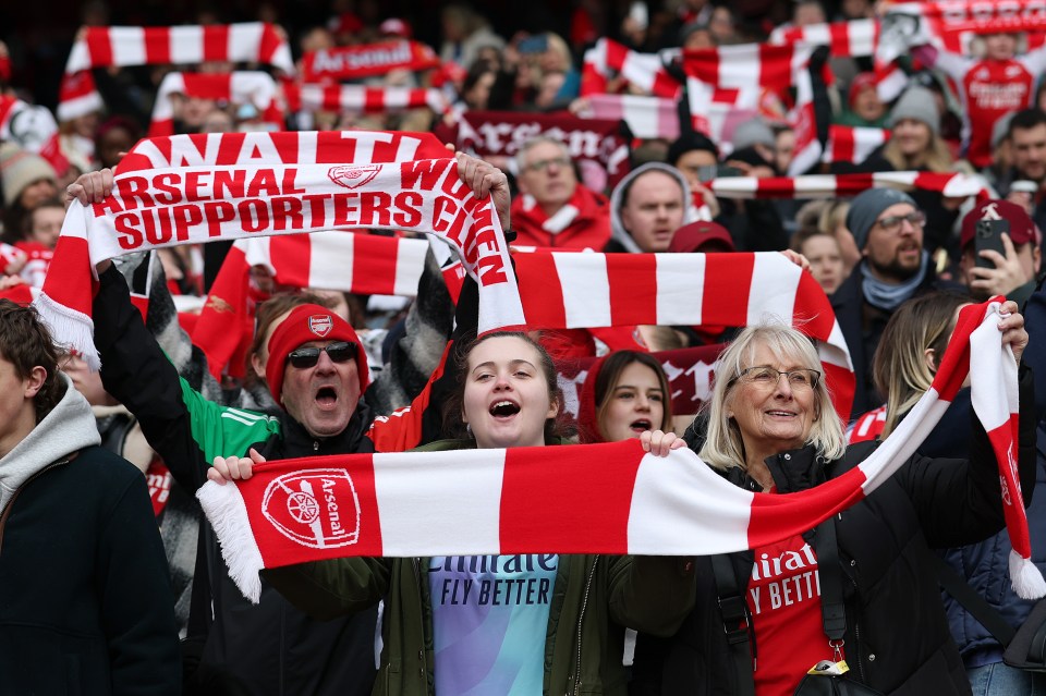 Arsenal fans holding scarves before a Women's Super League match.