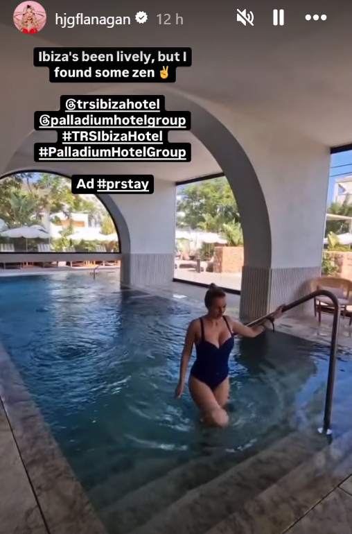 Woman in a blue swimsuit entering a resort pool.