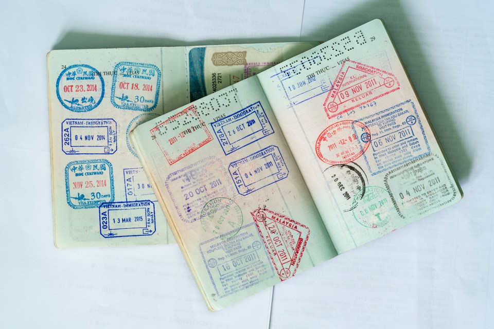 Passport pages with multiple entry and exit stamps.