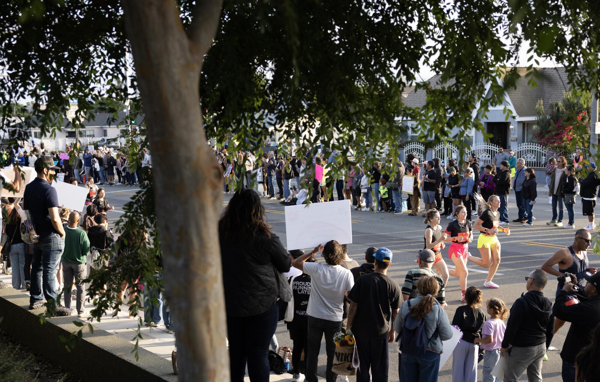 Hundreds of supporters line the course as runners embark on the Nike After Dark Tour in Los Angeles.