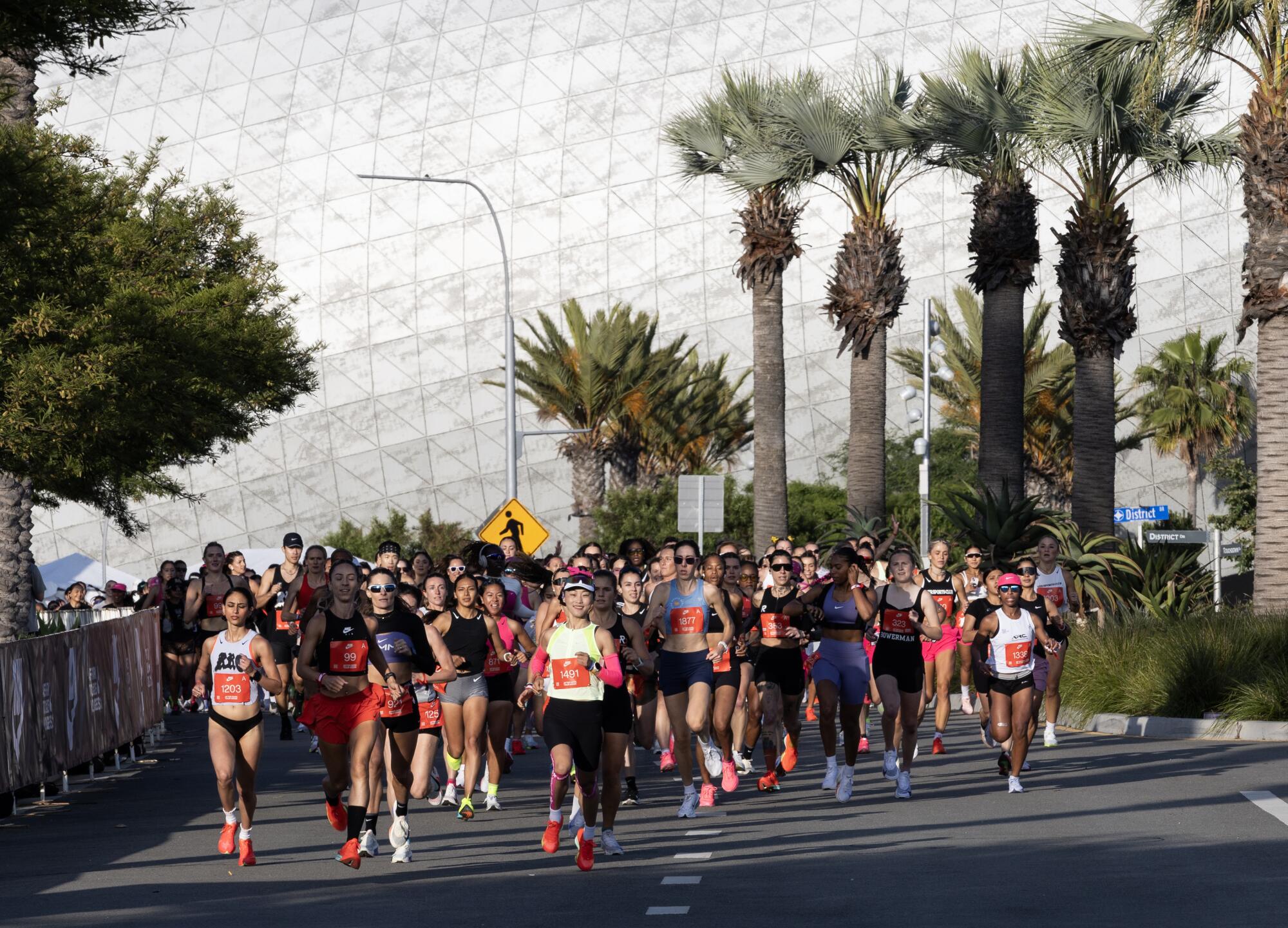 Runners take off for the women's half-marathon, which started at SoFi Stadium in Inglewood.