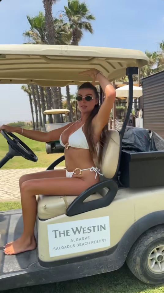 Woman in a white bikini driving a golf cart at The Westin Algarve Salgados Beach Resort.