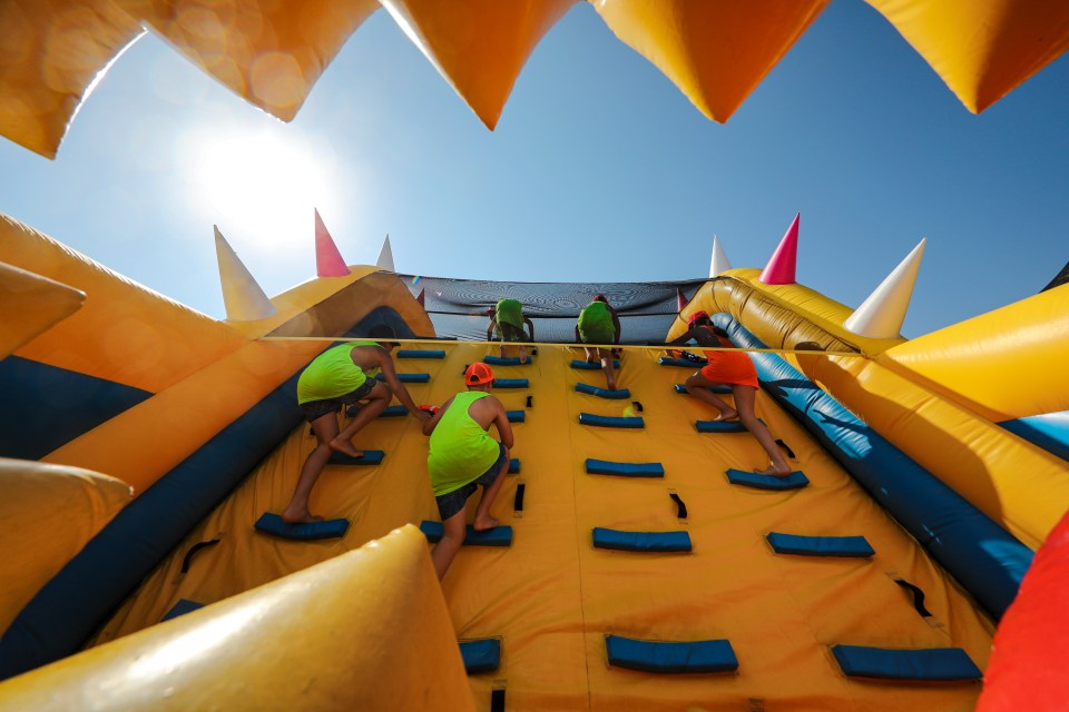 People climbing a large inflatable obstacle course.