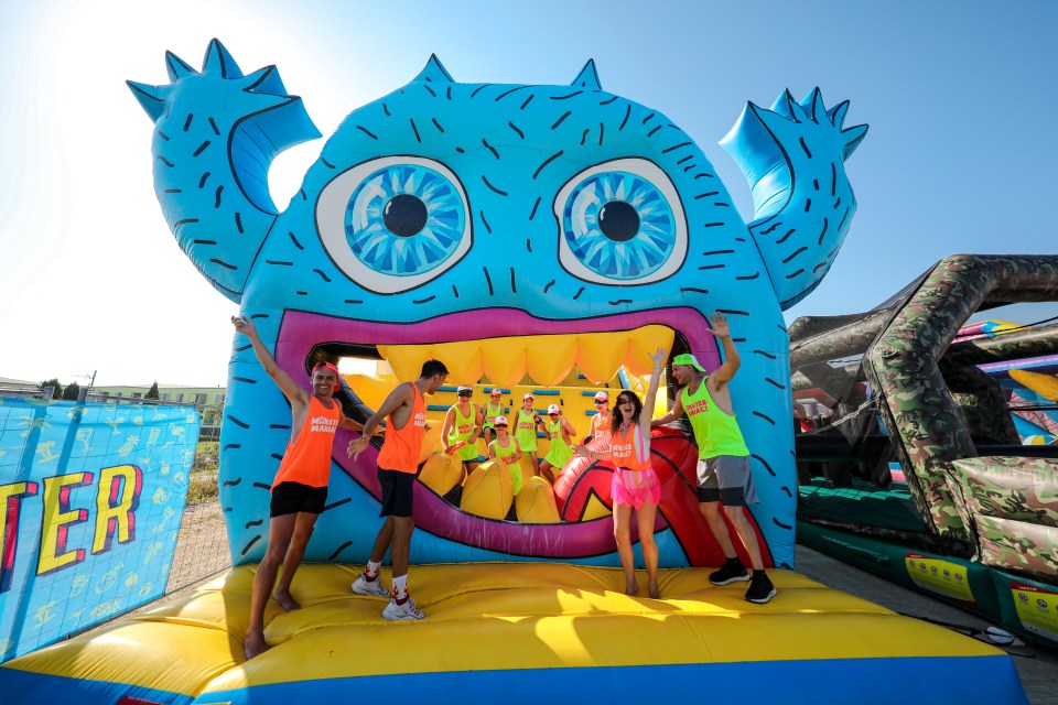 People enjoying a large inflatable obstacle course.
