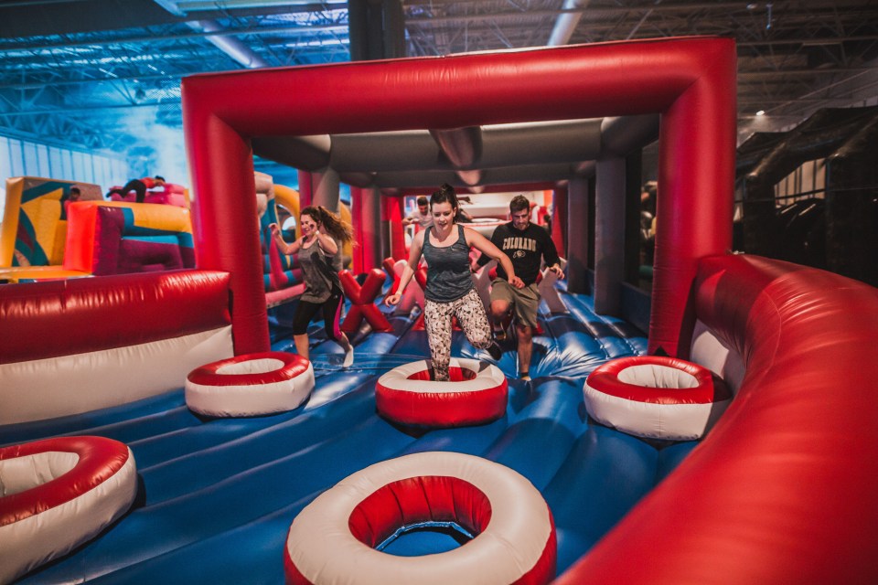 People navigating an inflatable obstacle course.