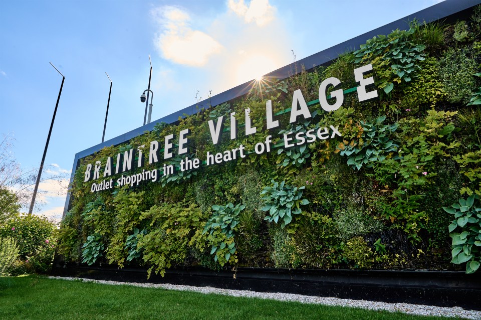 Braintree Village sign with a living wall; outlet shopping in the heart of Essex.