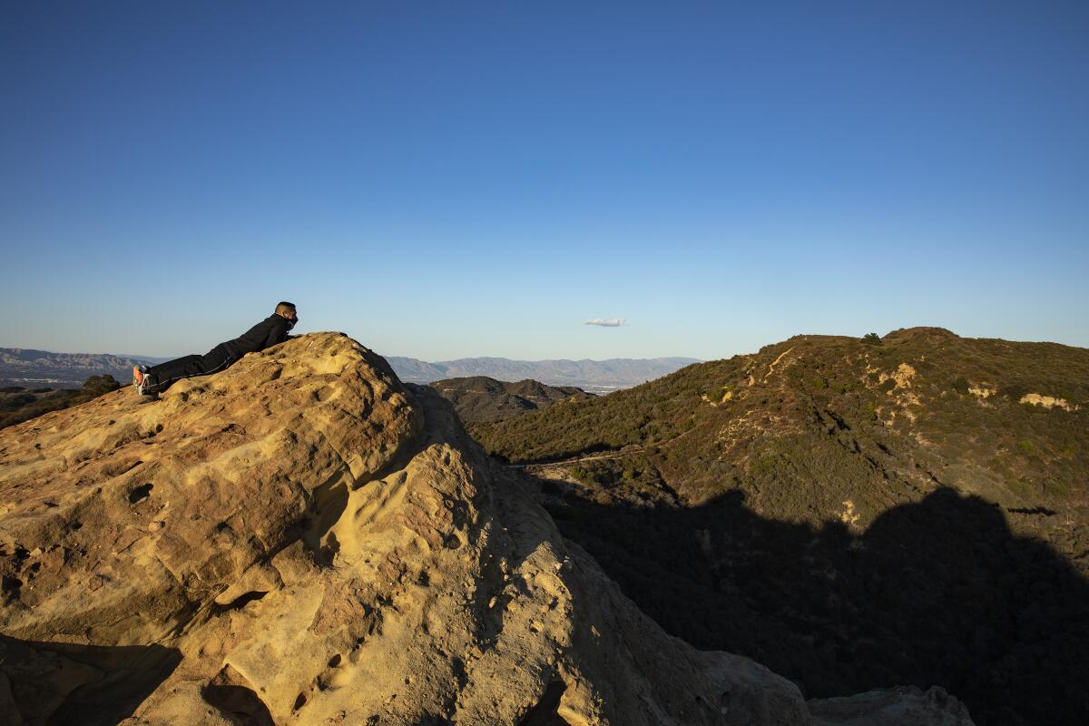 A lone hiker takes in sweeping views of the Santa Monica Mountains.