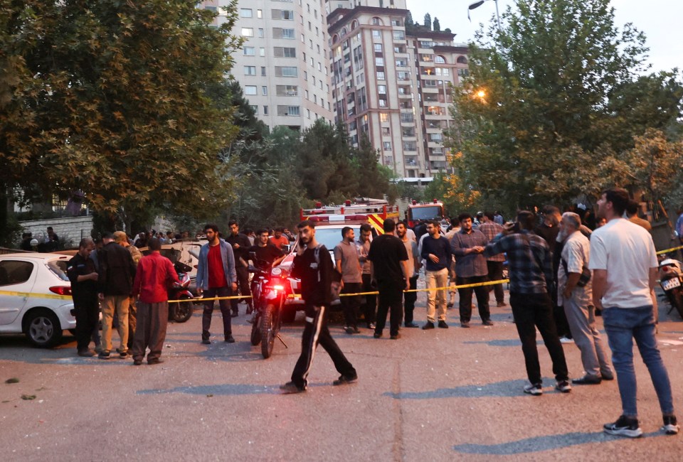 People gathered in a street in Tehran, Iran, after Israeli strikes.