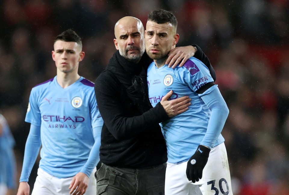 Pep Guardiola comforting Nicolas Otamendi after a Manchester City match.