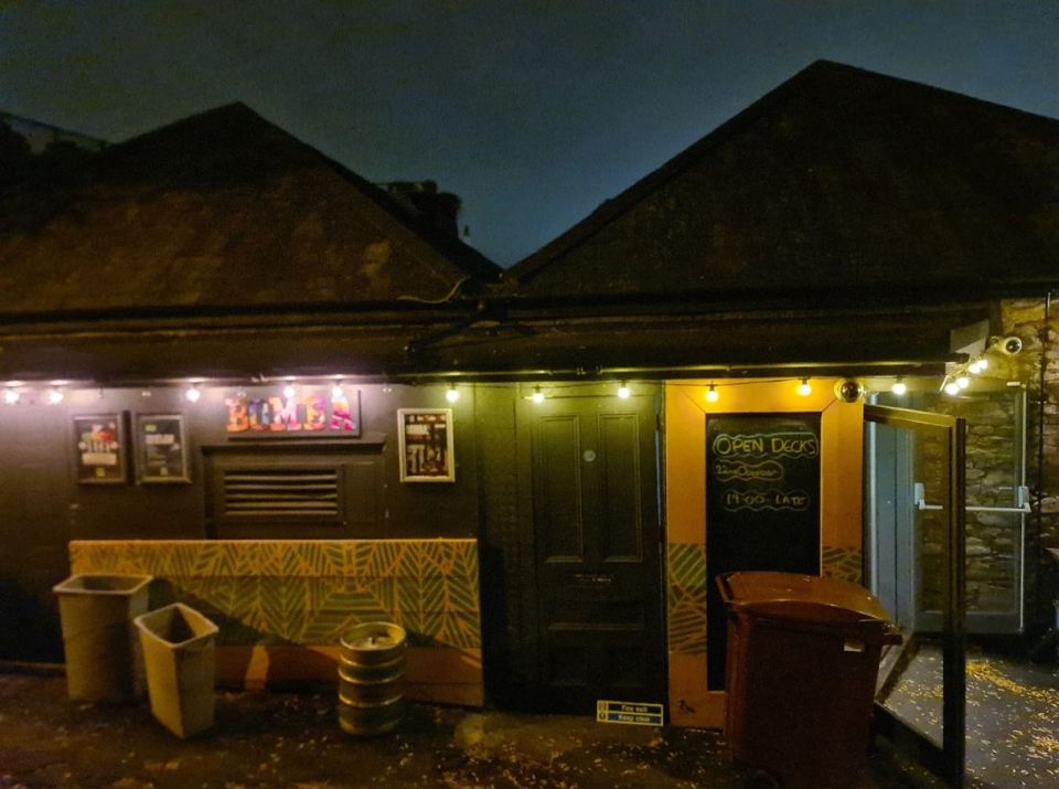 Nighttime photo of Boom Boom's and Open Decks bars.