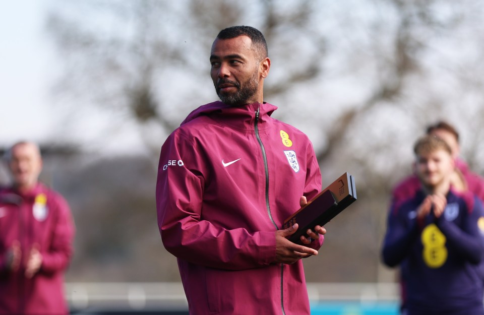Ashley Cole holding an award at his England National Football Museum Hall of Fame induction.