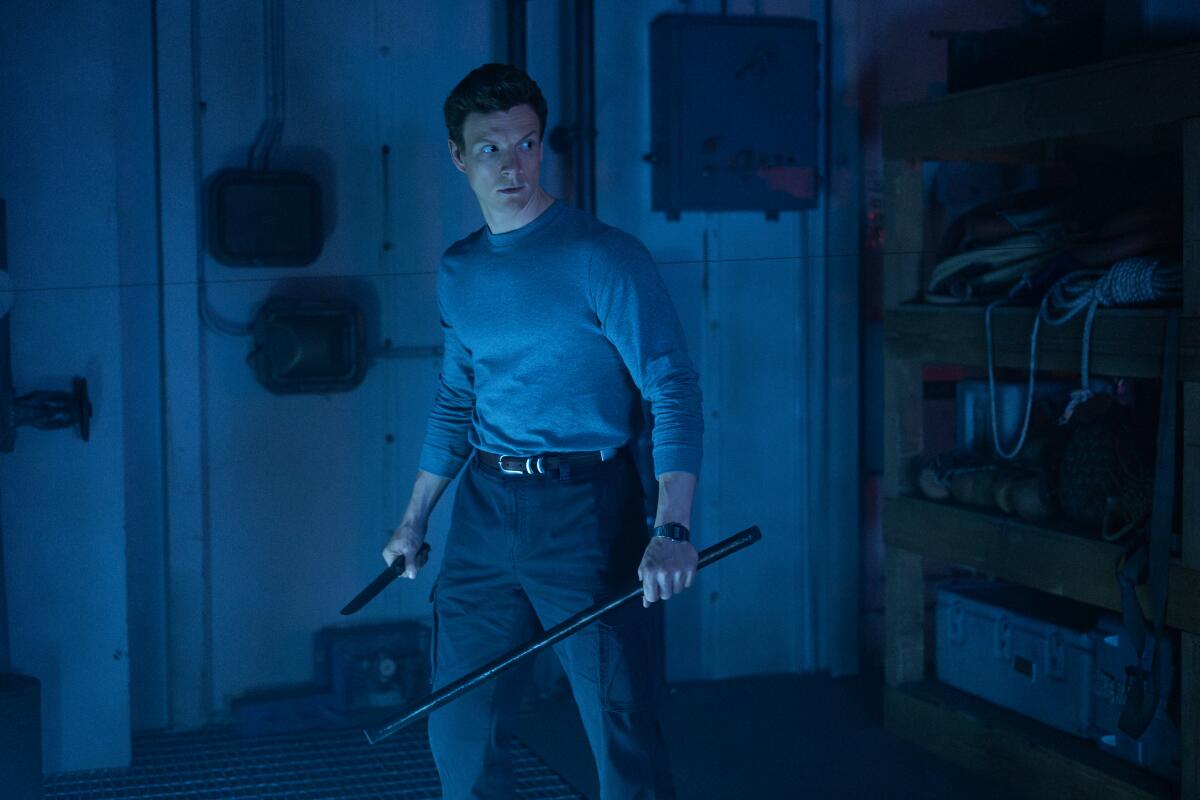 A man holding weapons