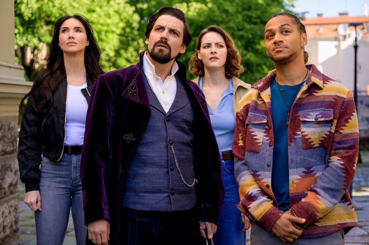 A group of people stand side by side