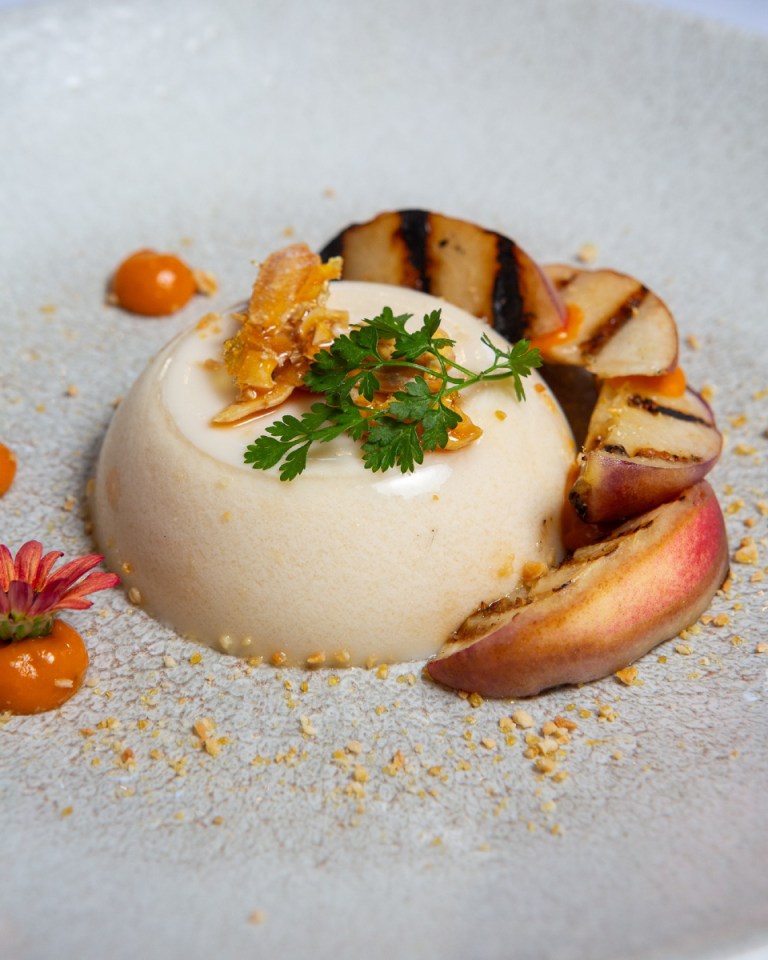 Panna cotta with grilled peaches and honey crumble.