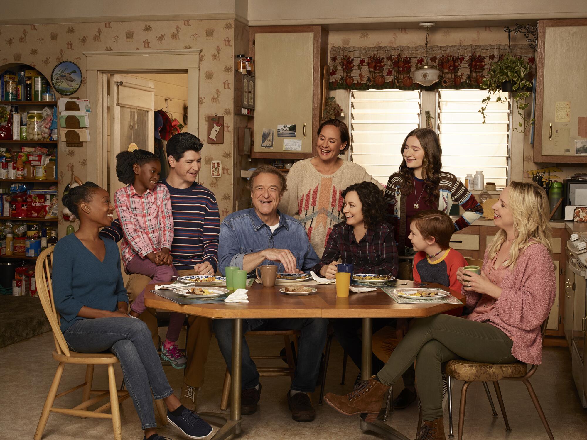Extended family sitting around the kitchen table on a TV sitcom